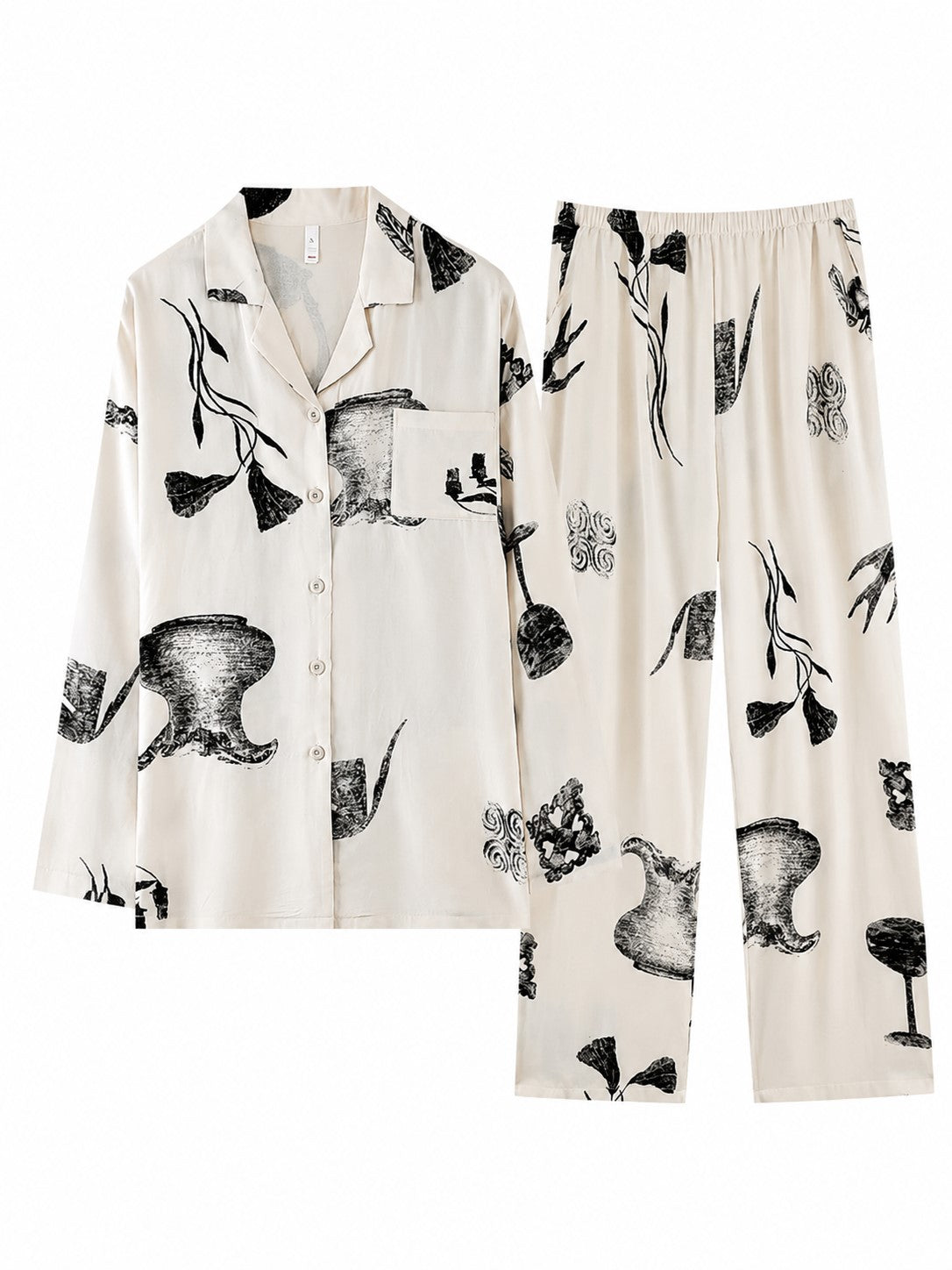 Ink Still Life Bamboo Pajama Set shown in a flat lay with long sleeve button-up top and full-length pants