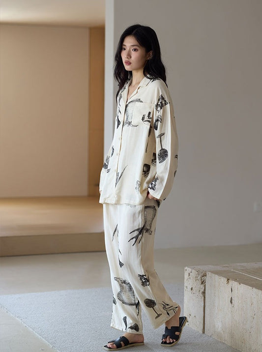 Woman wearing the Ink Still Life Bamboo Pajama Set standing indoors in a side-facing pose