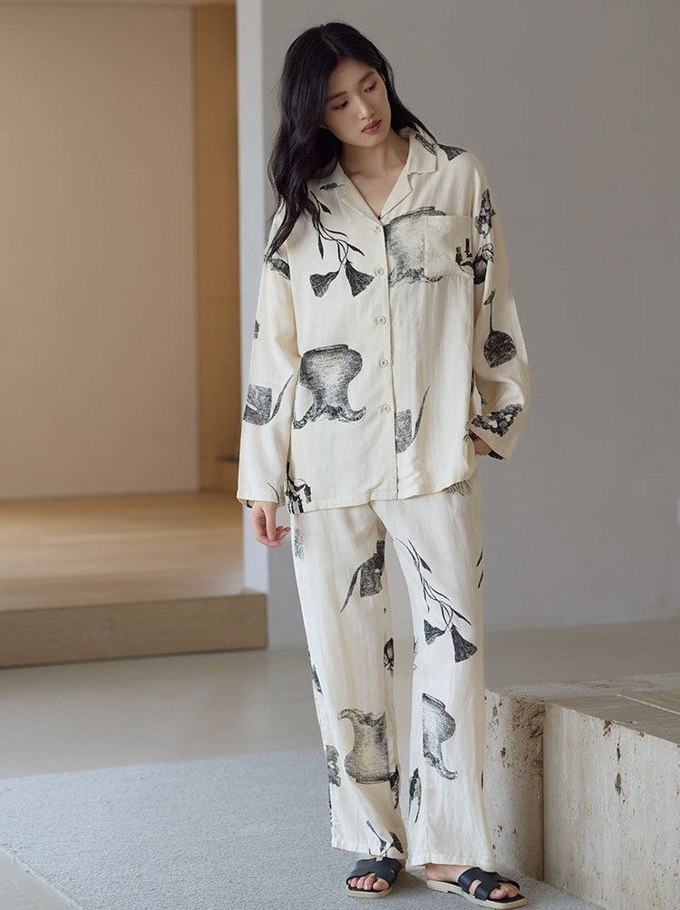 Front view of woman wearing the Ink Still Life Bamboo Pajama Set with long sleeve top and relaxed pants